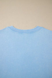 Light blue cotton relaxed V-neck top with ribbed neckline