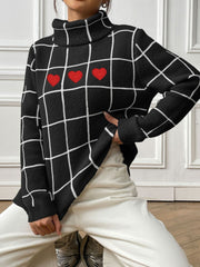 Black gridwork turtleneck sweater with red heart appliques.