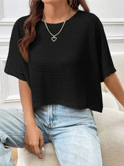 Black waffle-knit cropped t-shirt with crew neck and short sleeves.
