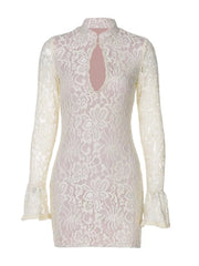 White lace cutout mini dress with flared sleeves and mock neck.