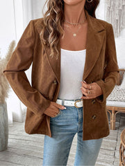 Brown corduroy double-breasted blazer with notched lapels and button details.