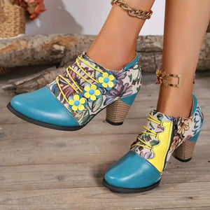 Floral patchwork ankle boots with blue toe, yellow laces, and flower details.