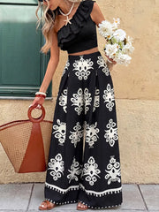 Black one-shoulder ruffled crop top with white printed wide-leg pants set
