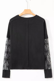 Black maternity t-shirt with lace-embellished sleeves and crew neck.