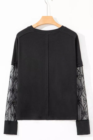 Black maternity t-shirt with lace-embellished sleeves and crew neck.