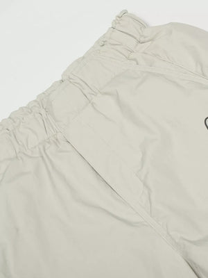 Men's light gray wide-leg sweatpants with elastic waistband and pocket detail.