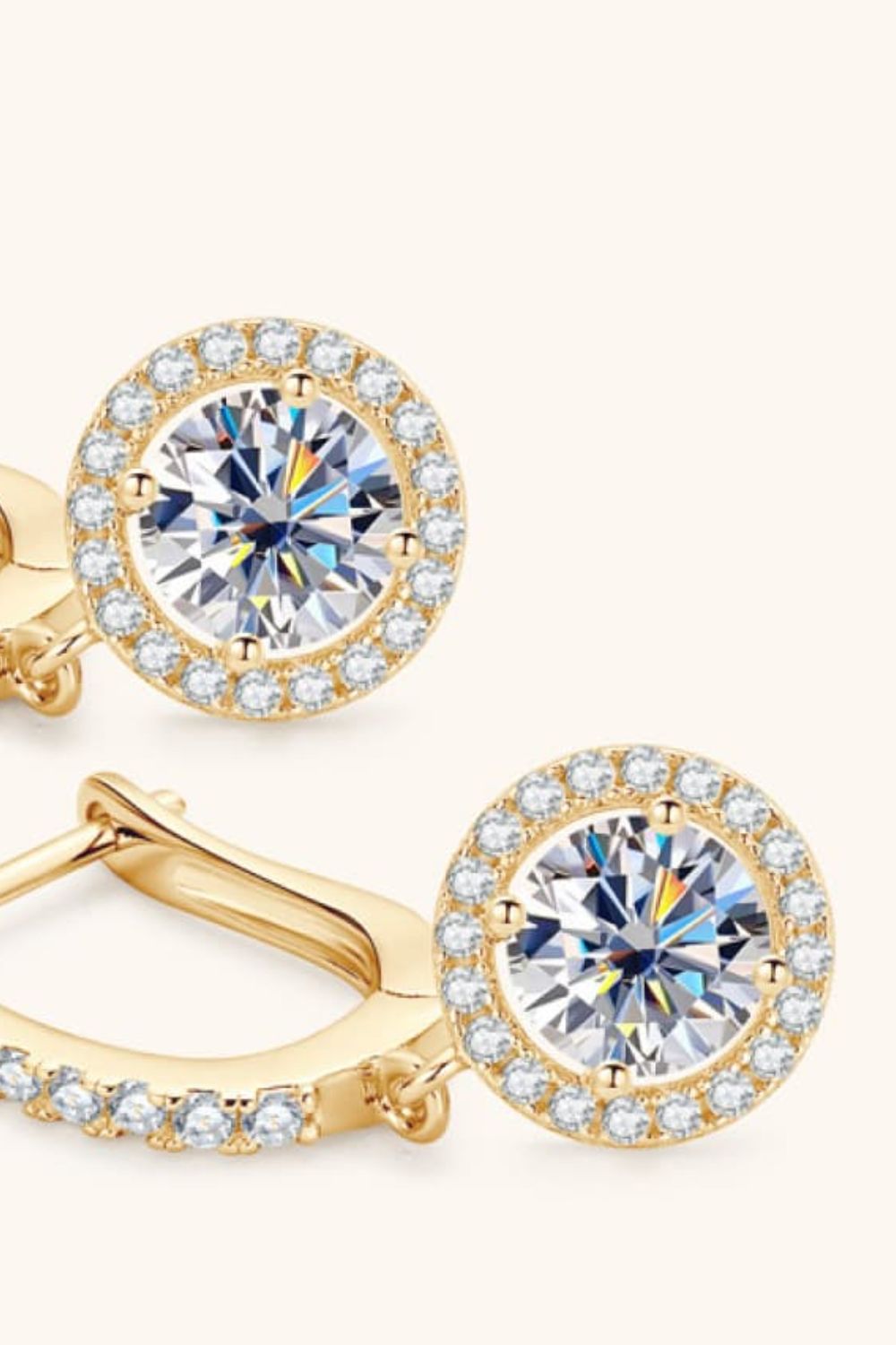 Gold pavé halo drop earrings with a central round-cut crystal.