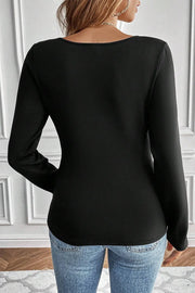 Black long sleeve thermal top with scoop neckline, styled with jeans.