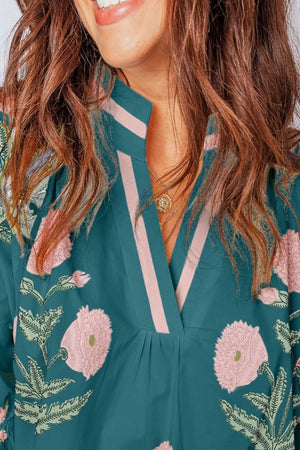 Dark green cotton blend blouse with floral embroidery and pink stripe detail at notched neckline.