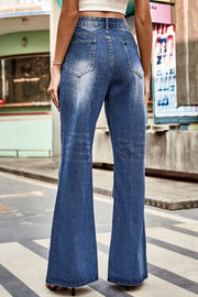 Flared denim jeans in medium blue with subtle distressing and a button closure.
