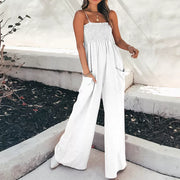 White smocked wide leg romper with spaghetti straps and side pockets.