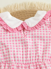 Pink gingham baby one-piece with white Peter Pan collar and ruffled trim