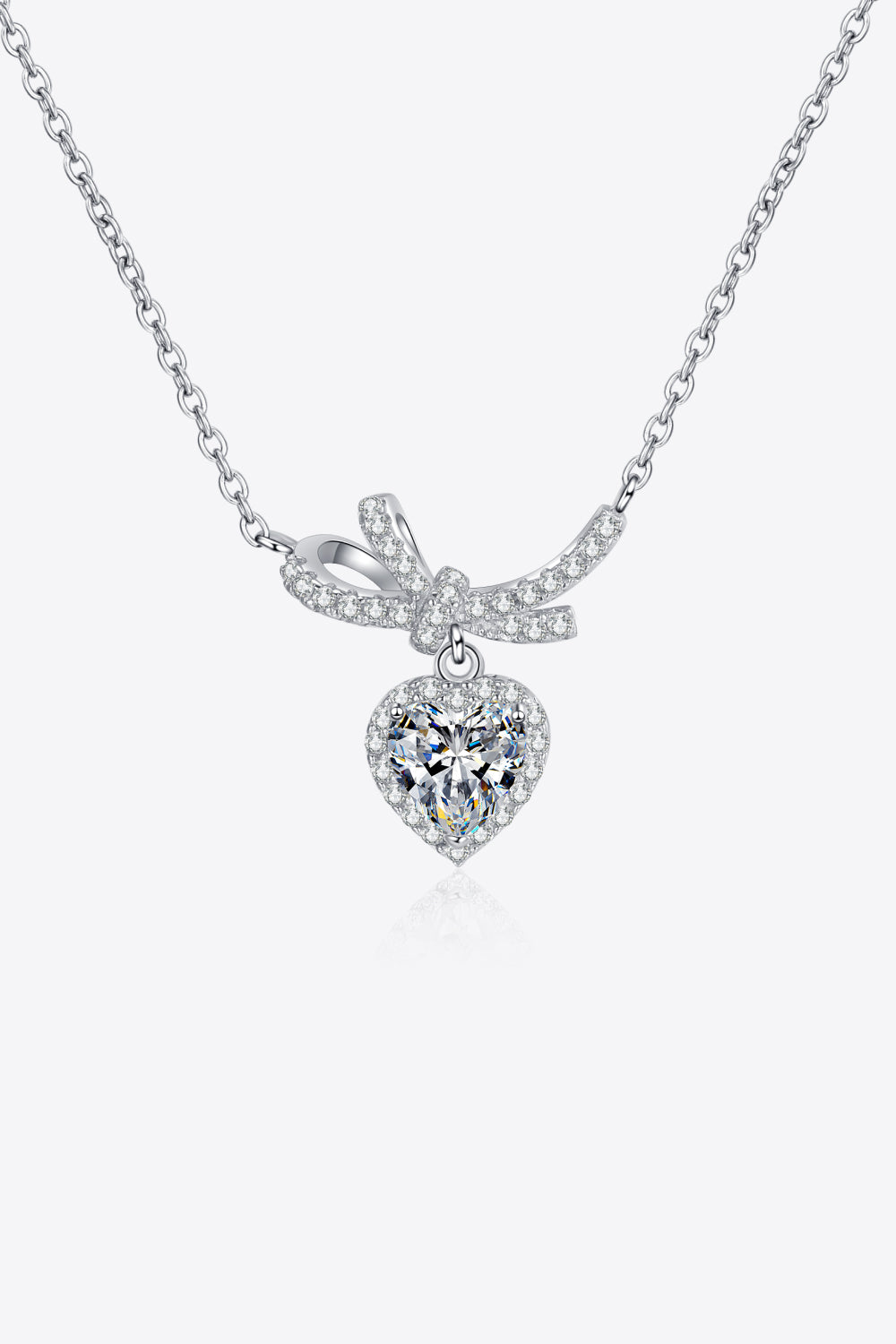 Silver necklace with cubic zirconia heart pendant and bow accent