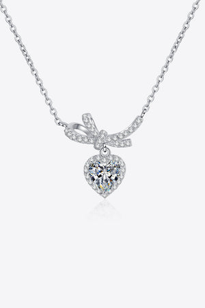 Silver necklace with cubic zirconia heart pendant and bow accent