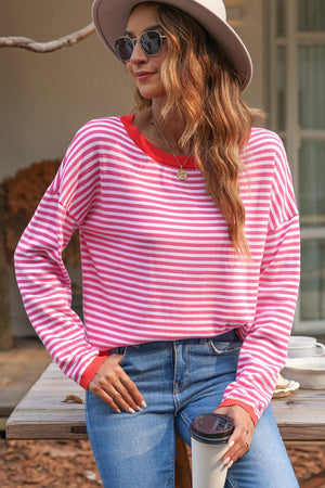 Nautical knit crewneck sweater with pink and white stripes and red contrast trim.