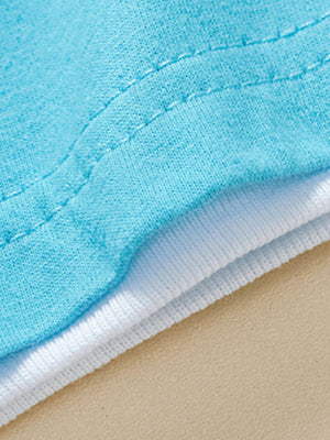 Close-up of blue and white layered cotton baby tee with visible stitching.