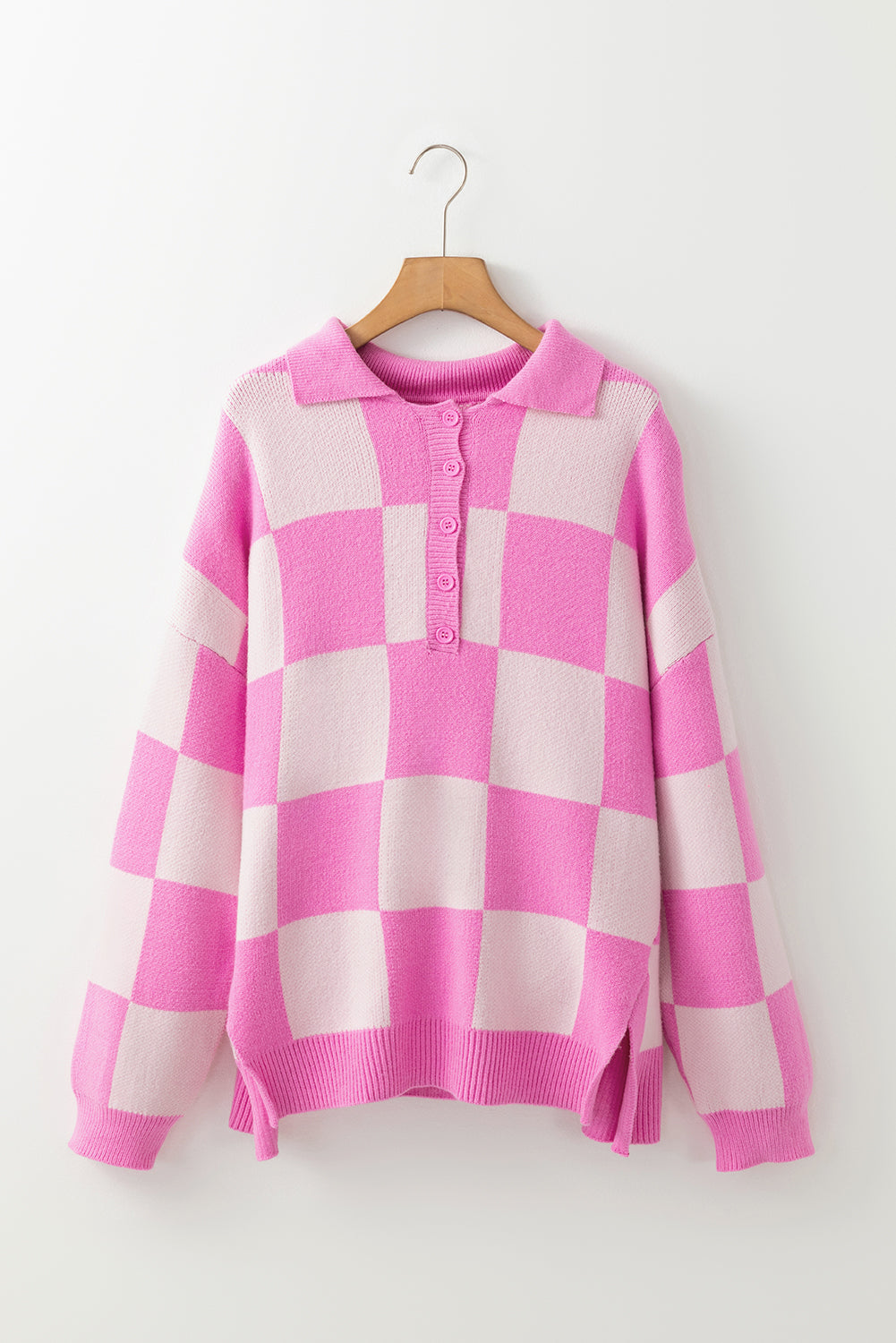 Fuchsia pink checkered knit polo sweater with button neckline and long sleeves.