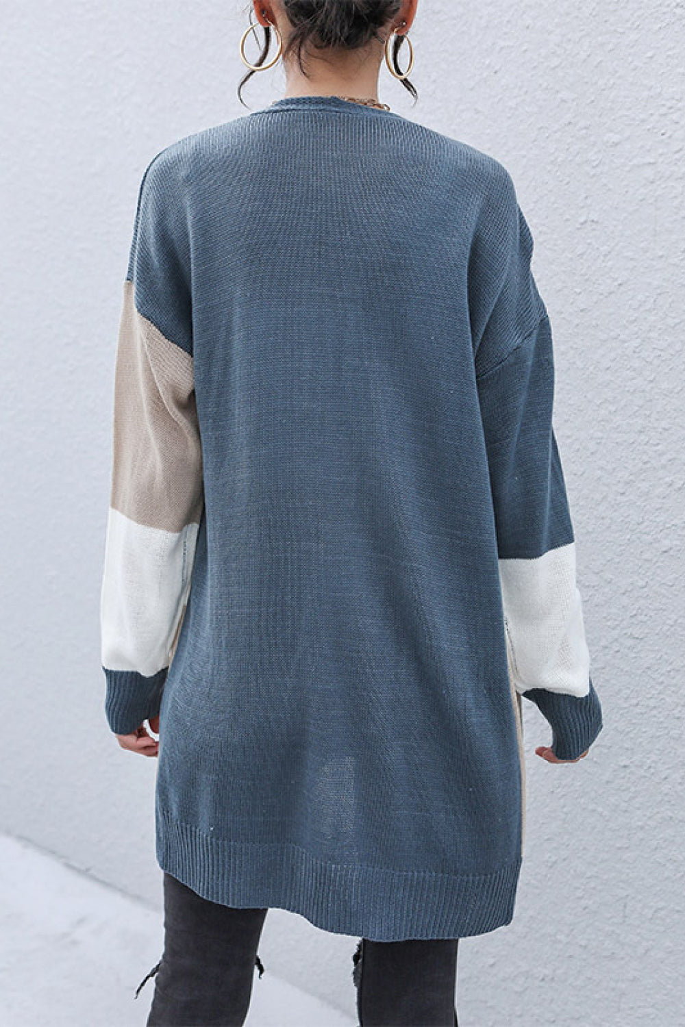 Geometric panel knit cardigan in blue/khaki with colorblock sleeves.