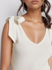 White ribbed knit tank top with bow shoulder details and V-neck.
