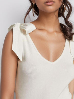 White ribbed knit tank top with bow shoulder details and V-neck.