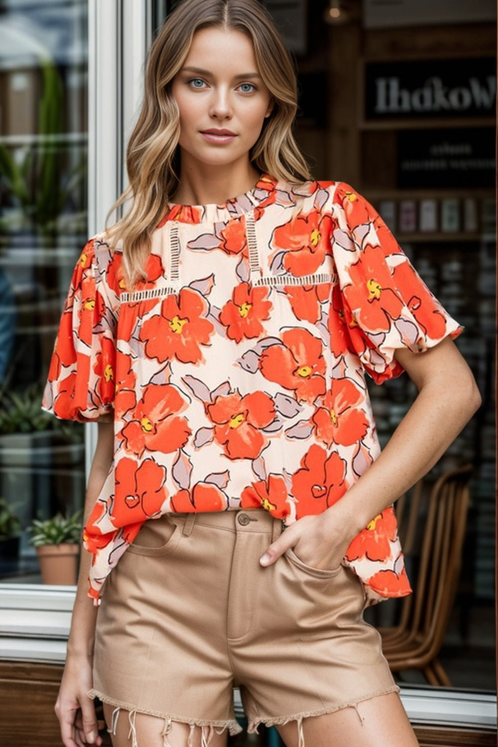 Floral print blouse with flutter sleeves in caramel, featuring a round neckline and lace trim detail.