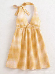 Yellow gingham mini dress with tie halter straps and a V-neck.