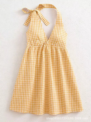 Yellow gingham mini dress with tie halter straps and a V-neck.