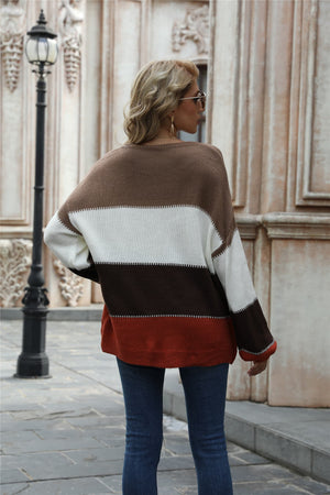 Acrylic crewneck sweater with horizontal color blocks in brown, white, dark brown, and rust.