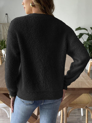 Black plush button-down cardigan with pearl details and ribbed cuffs.
