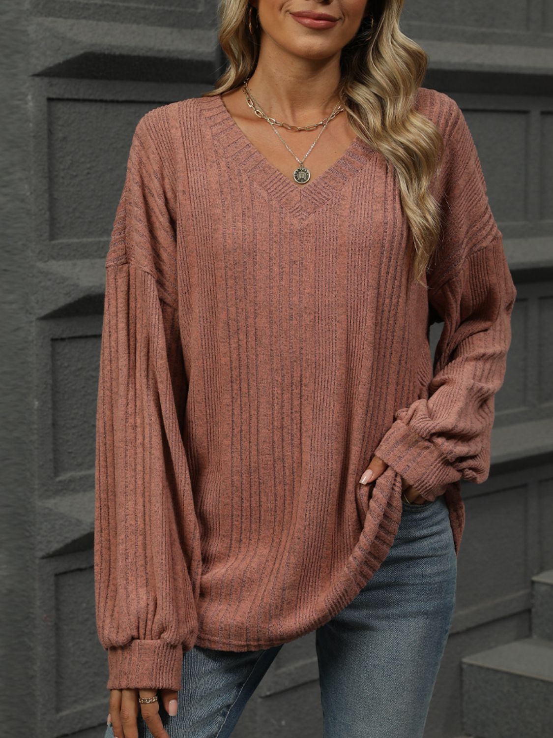 Textured ribbed v-neck blouse in rust with blouson sleeves and a relaxed fit.