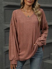 Textured ribbed v-neck blouse in rust with blouson sleeves and a relaxed fit.