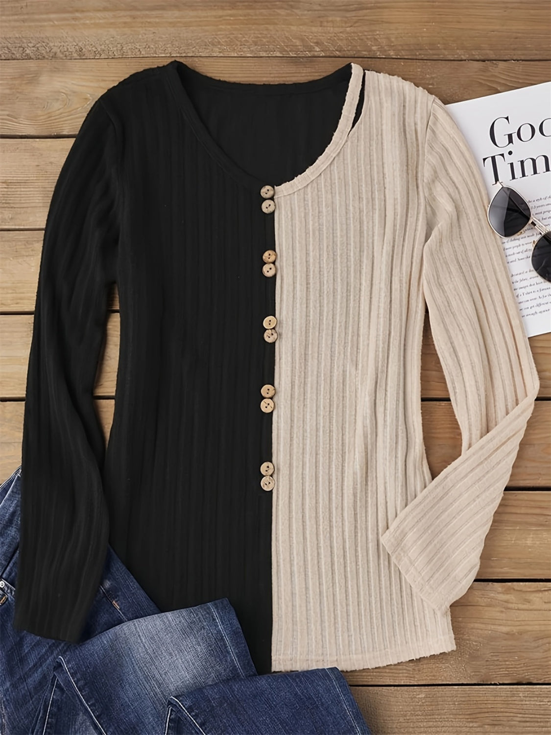 Split-panel ribbed henley top in black and beige with button front detail.