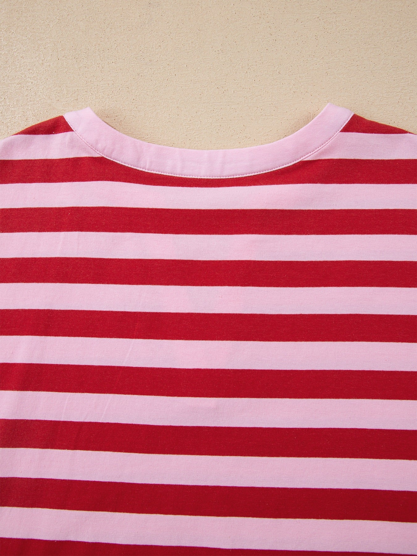 Red and pink striped cotton blend t-shirt with a split V-neckline.