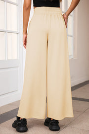 Palazzo joggers in Pastel Yellow with elastic waist and center seam detail.