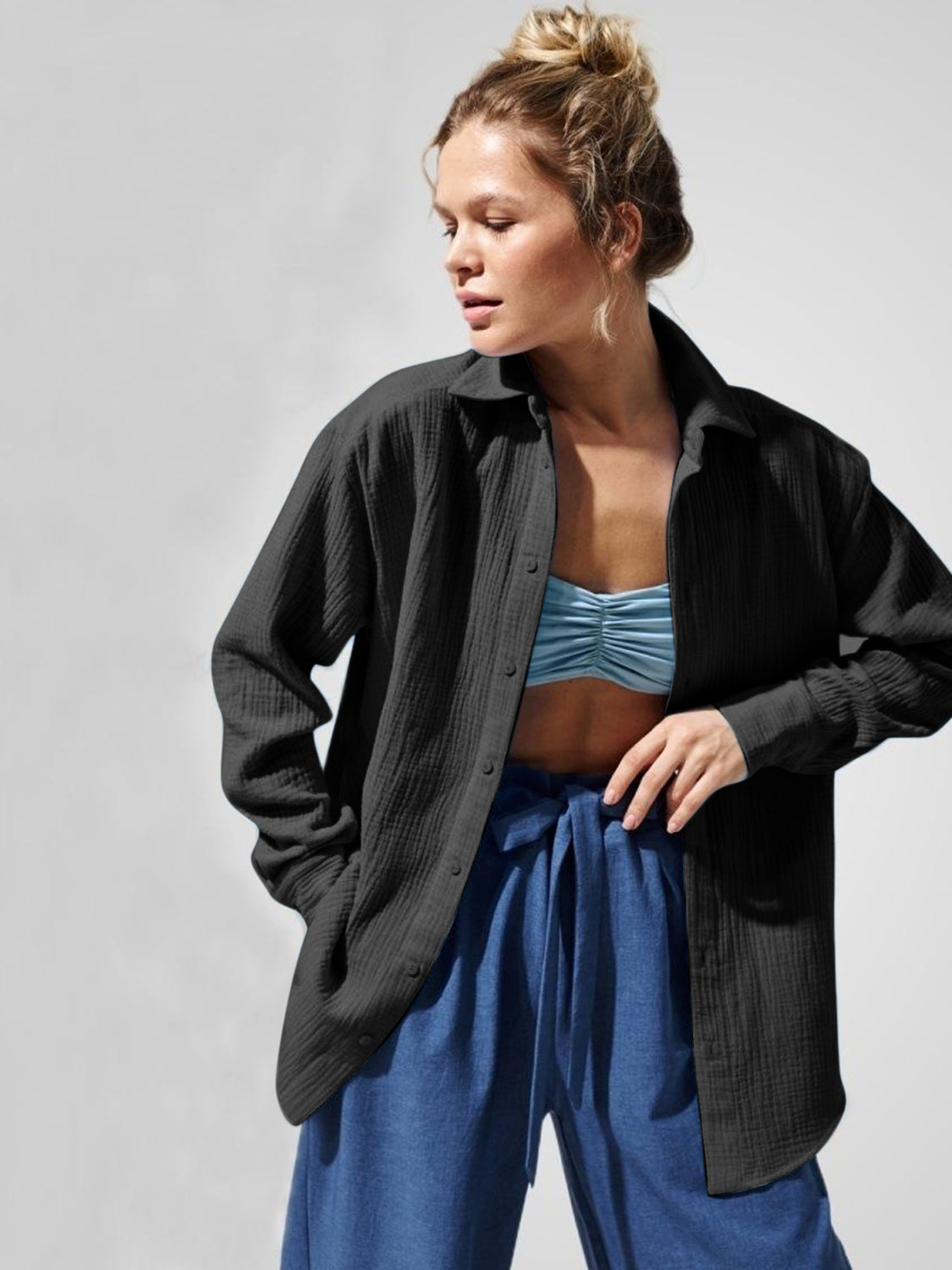 Black textured cotton overshirt with relaxed fit and button front, styled open over a blue bralette.