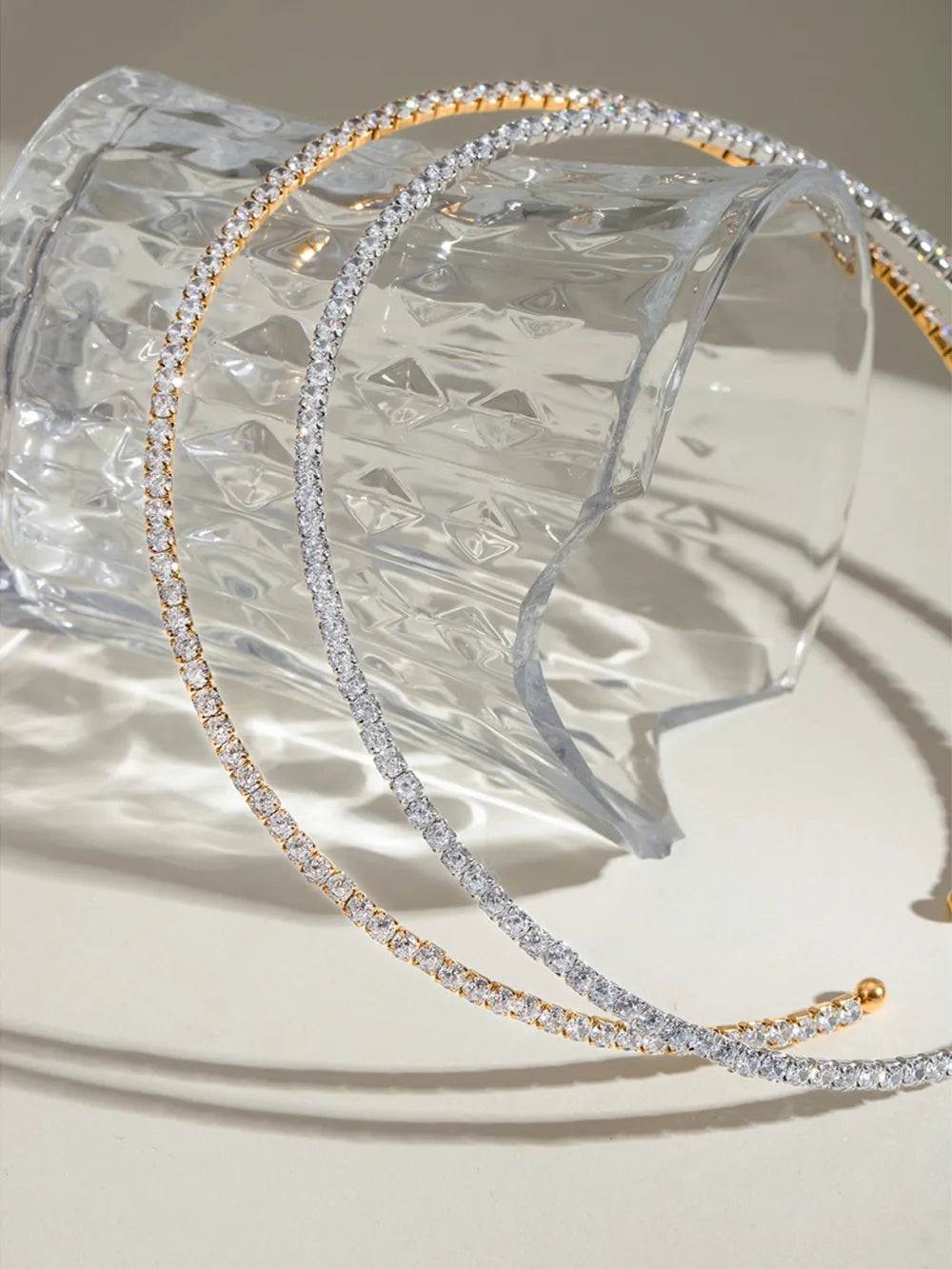 Diamond row collar necklaces in gold and silver with sparkling stones.