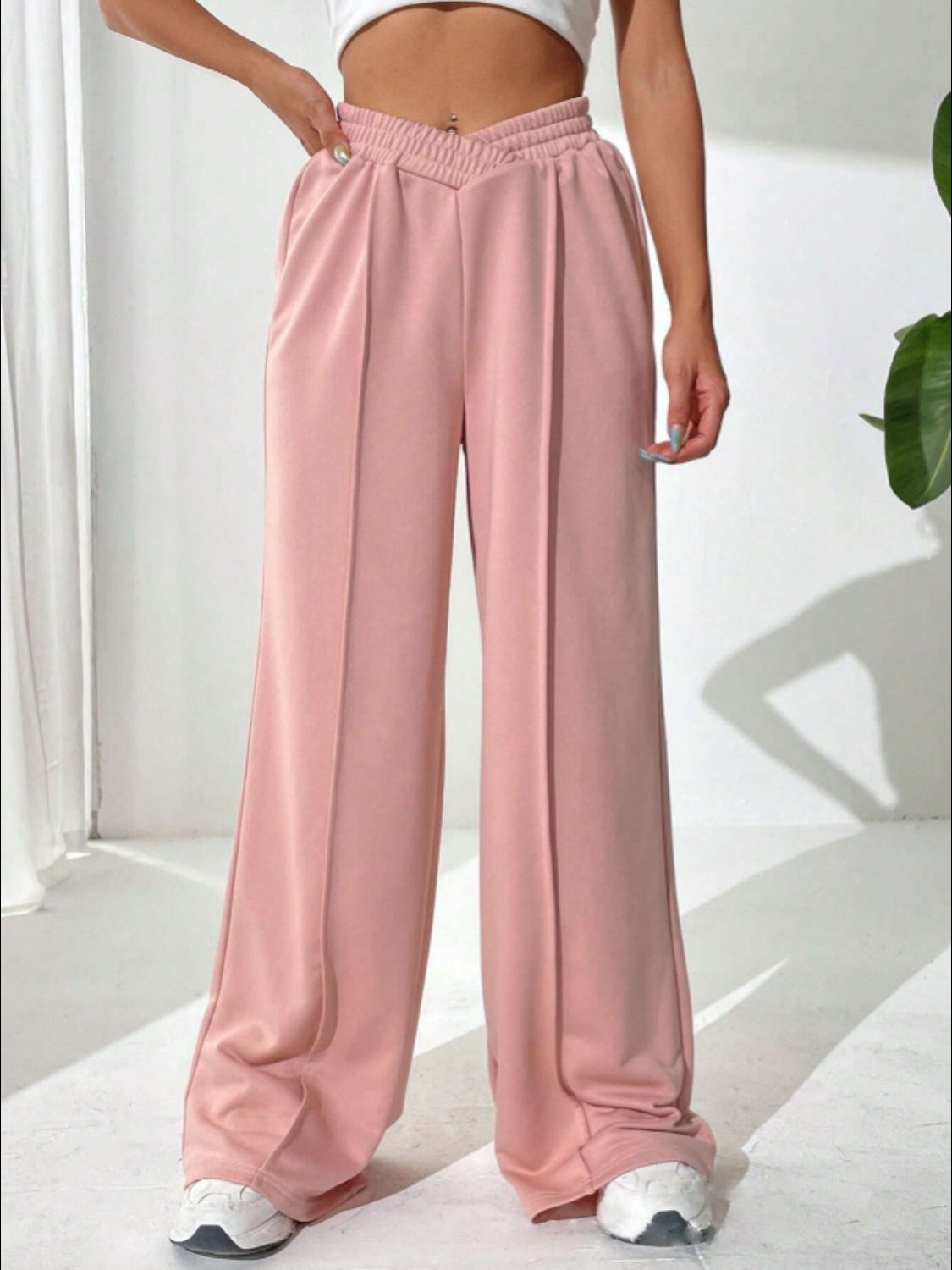 Blush pink palazzo sweatpants with V-waistline and center seams