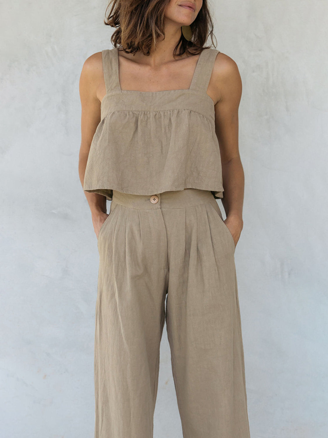 Khaki linen crop top with square neckline and culotte pants with button detail.