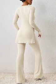 Cream ribbed knit co-ord set with flared pants and side slit tunic.
