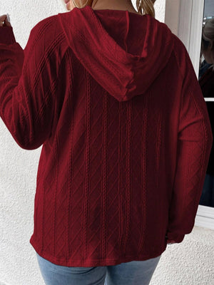 Burgundy textured knit raglan hoodie with cable knit detail.