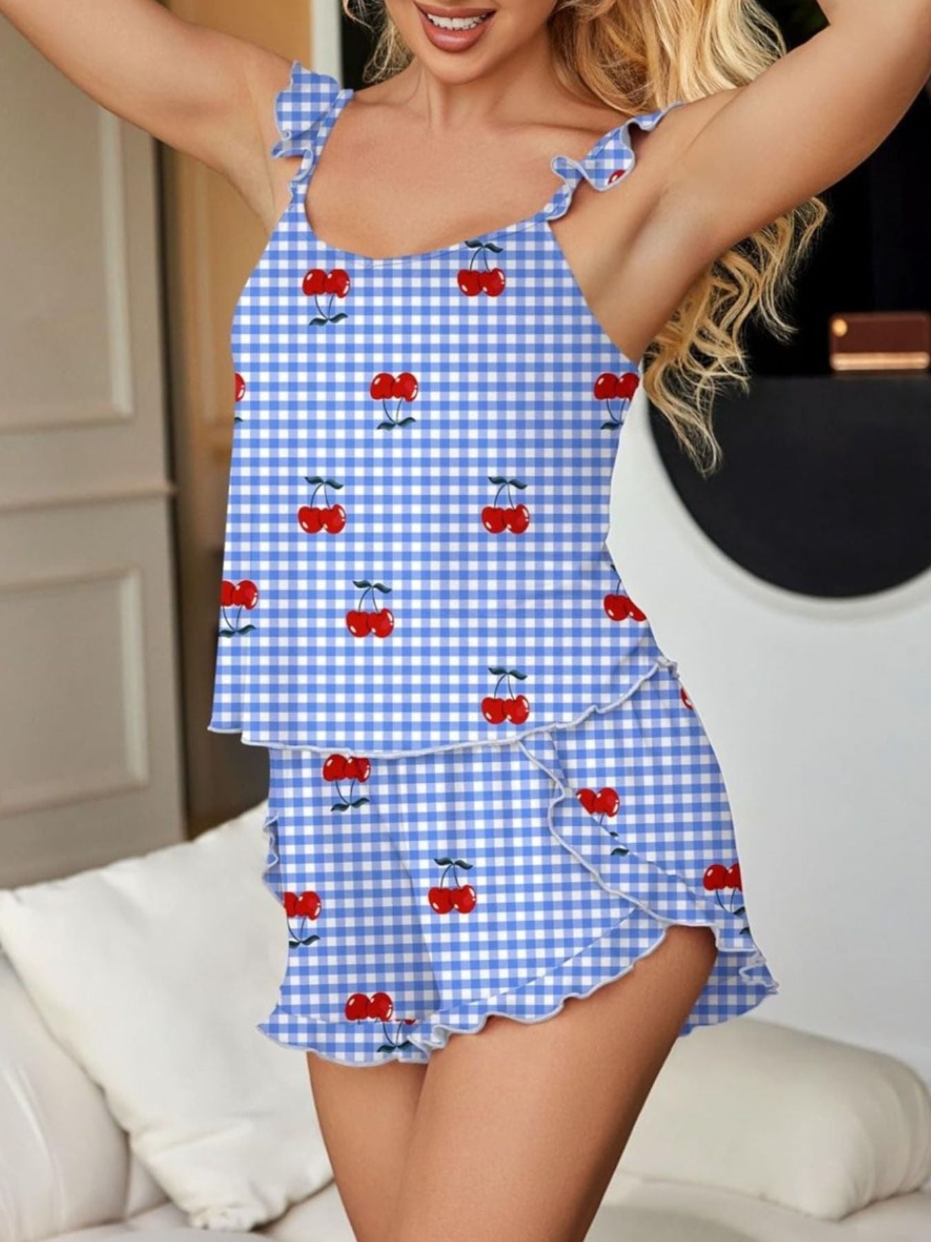 Ruffled cami and shorts set in blue gingham with cherry print, featuring ruffled straps and hem.