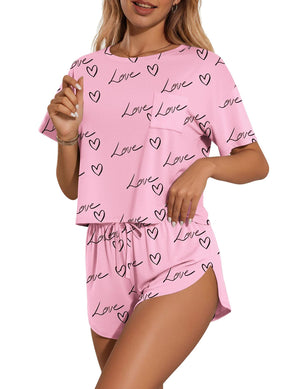 Pink pajama set with heart and love print, crew neck tee with pocket, and drawstring shorts.