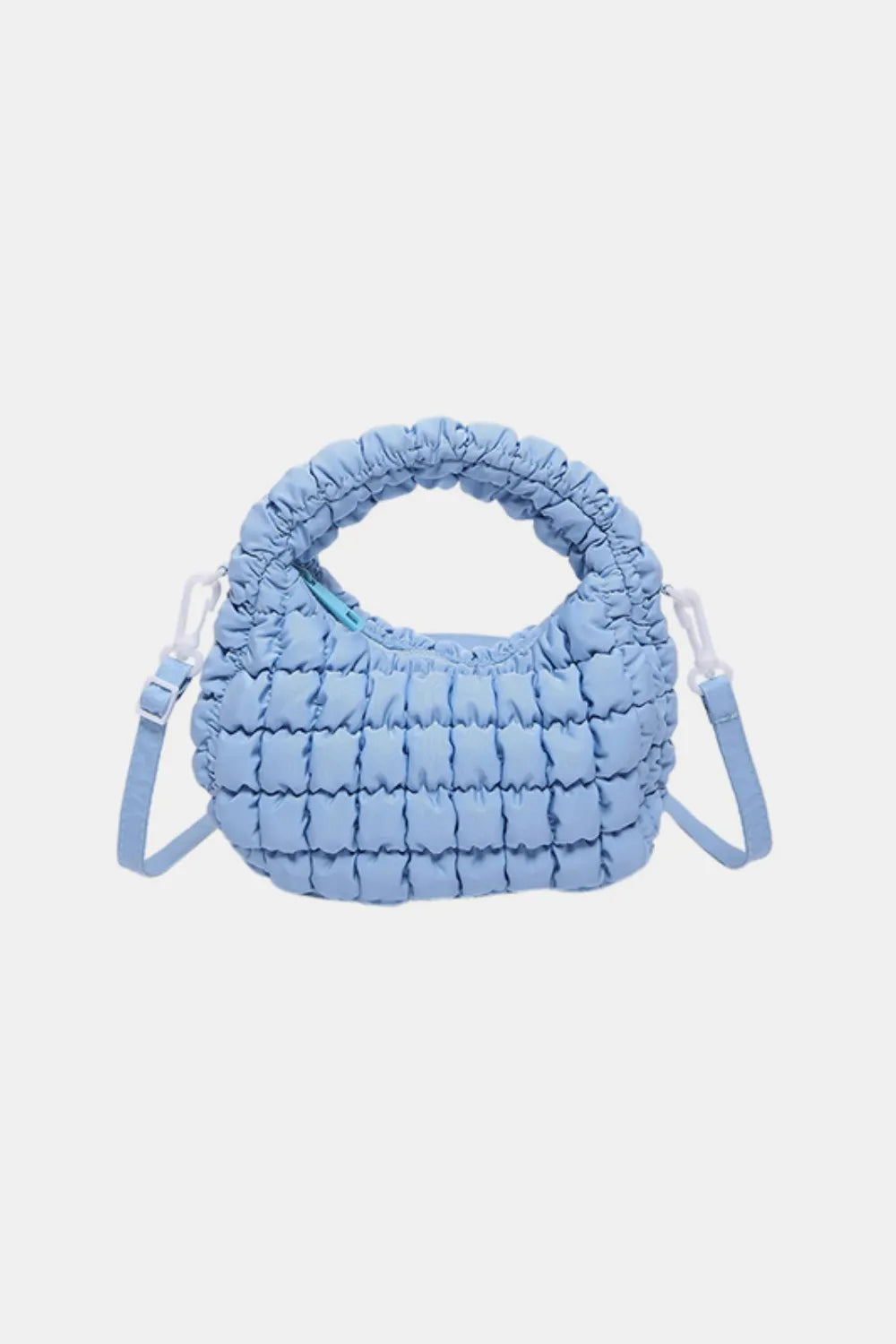 Pastel blue padded crescent crossbody bag with ruched handle and adjustable strap.
