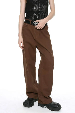 Brown wide-leg denim jeans with angular seams and a relaxed fit.