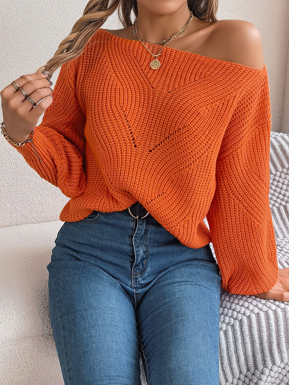 Orange off-the-shoulder knit sweater with openwork detail and V-neck