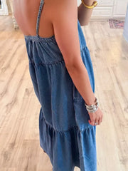 Blue denim tiered ruffle midi dress with spaghetti straps and a relaxed fit.