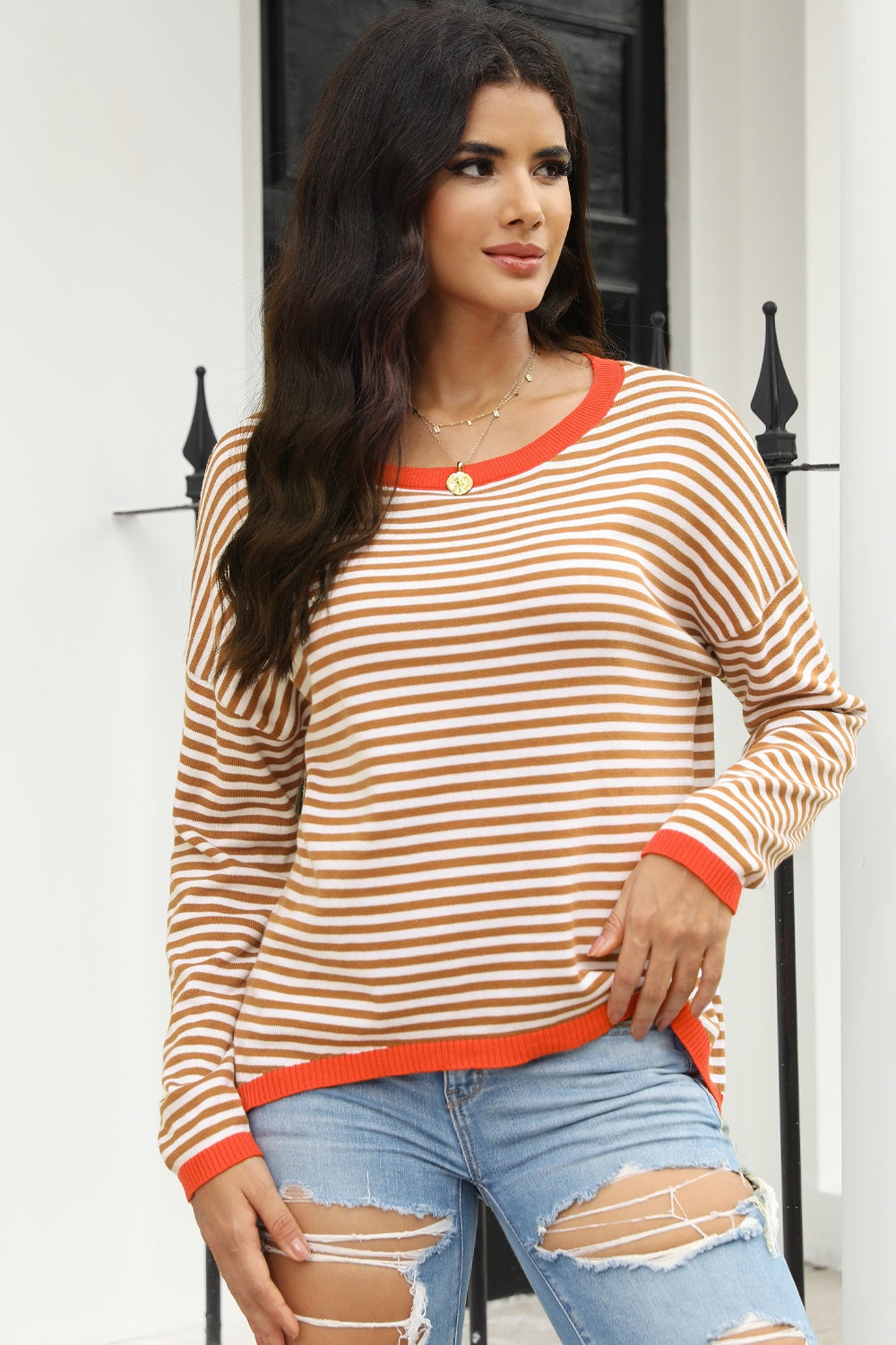 Striped crewneck sweater with contrast orange trim and neckline