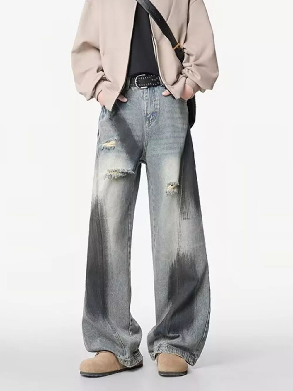 Distressed wide-leg jeans with a gradient wash and belted detail.