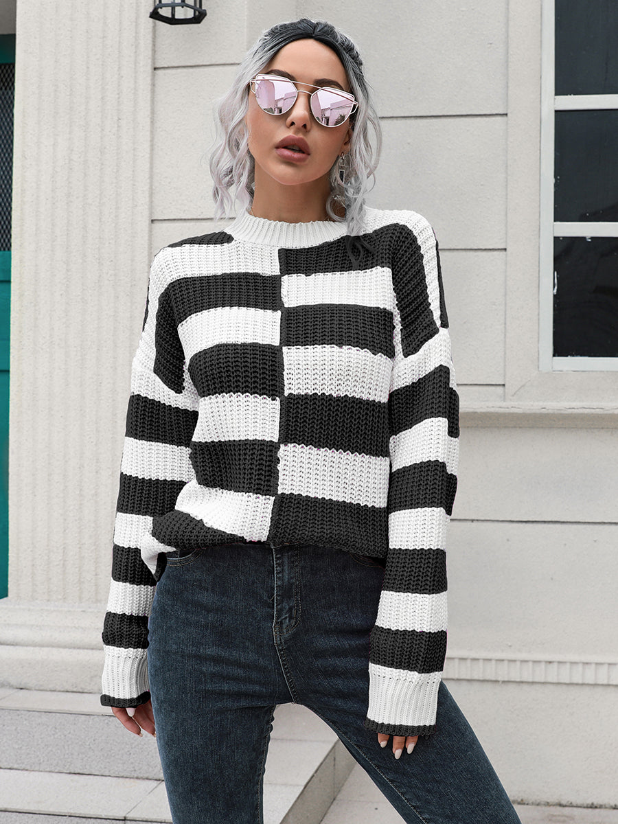 Black and white striped acrylic sweater with a checkerboard pattern detail and bow accent.