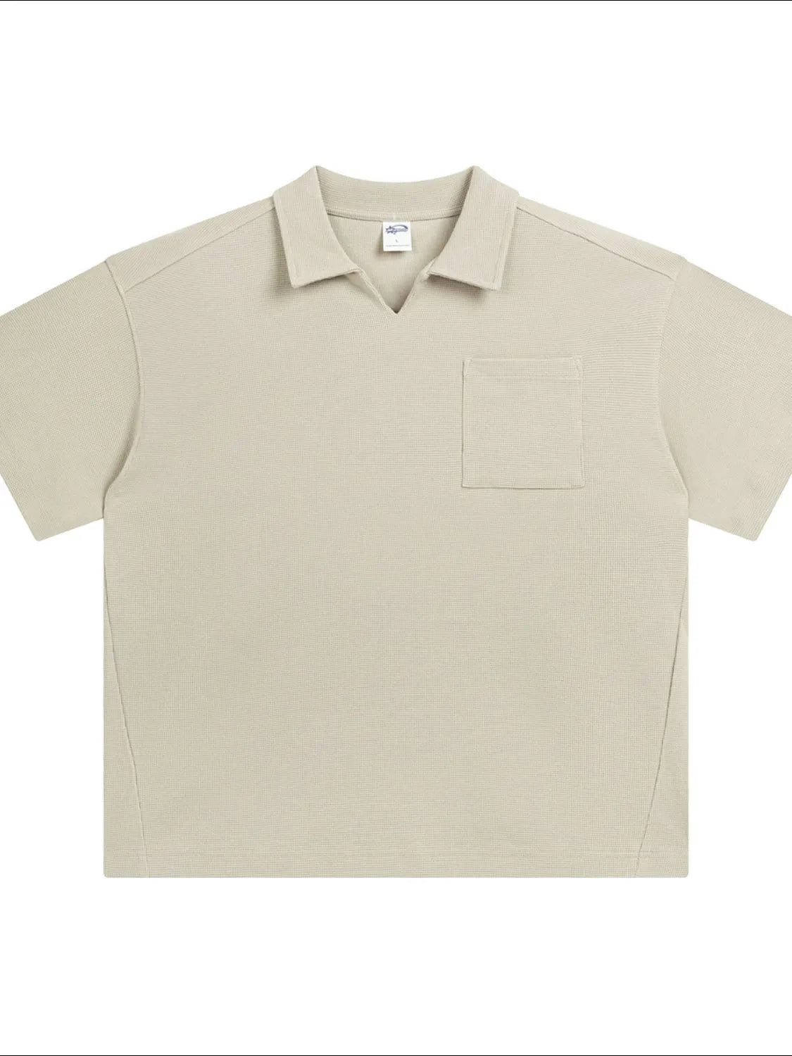 Beige boxy knit polo shirt with short sleeves, V-neck, and a patch pocket.